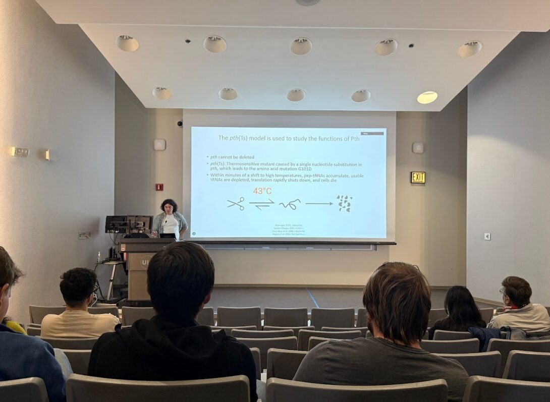 Alex presenting his thesis inside a classroom