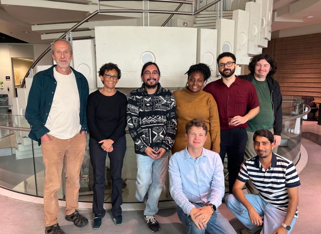 Lab members pose in front of the MBRB staircase with Kasra