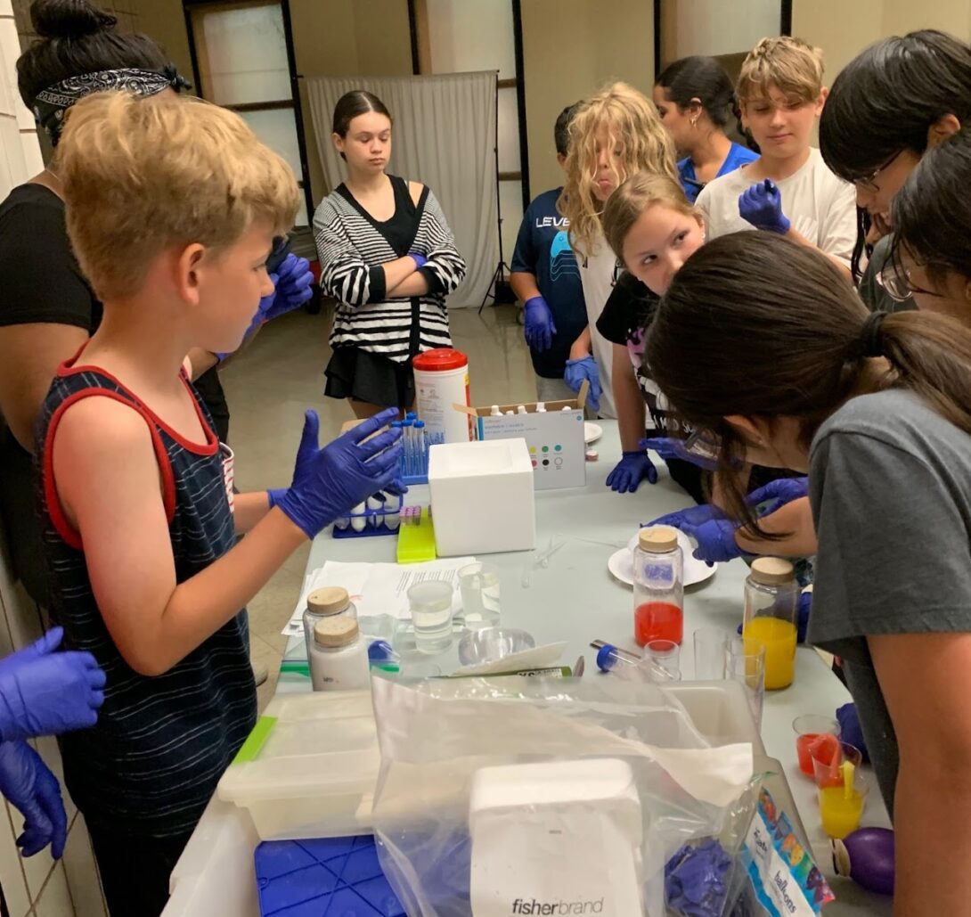 kids work with science equipment at a table